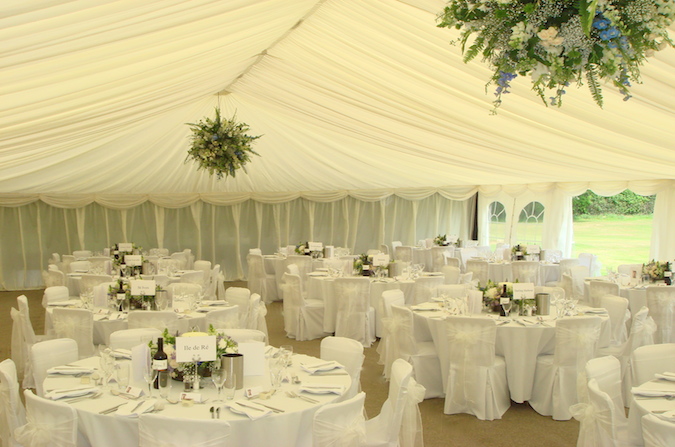 Hanging flowersballs, chair covers & revealed off starlit dancefloor. www.camelotmarquees.co.uk